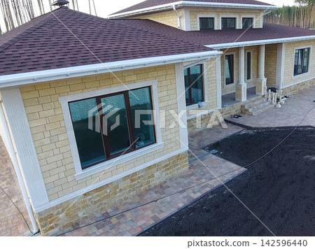 Bituminous tile for a roof. House with a roof from a bituminous Bituminous tile for a roof. House with a roof from a bituminous 142596440
