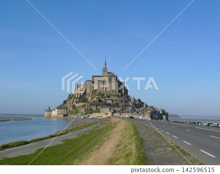 A view of Mont Saint-Michel, a World Heritage Site, and the old road in 2008, standing under a clear blue sky. A view of Mont Saint-Michel, a World Heritage Site, and the old road in 2008, standing under a clear blue sky. 142596515