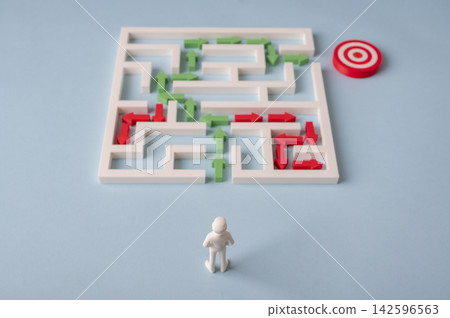 Businessman choosing the correct route through maze while avoiding dead ends Businessman choosing the correct route through maze while avoiding dead ends 142596563