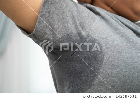 Sweaty underarms, Asian woman with sweat on clothes under armpit. Sweaty underarms, Asian woman with sweat on clothes under armpit. 142597531