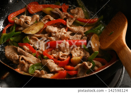 Stir-fried eggplant, green pepper, and pork with miso while cooking Stir-fried eggplant, green pepper, and pork with miso while cooking 142598124