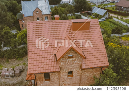 Corrugated metal roof and metal roofing. Modern roof made of metal. Corrugated metal roof and metal roofing. Modern roof made of metal. 142598306