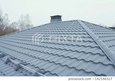 Corrugated metal roof and metal roofing. Modern roof made of metal. Corrugated metal roof and metal roofing. Modern roof made of metal. 142598327