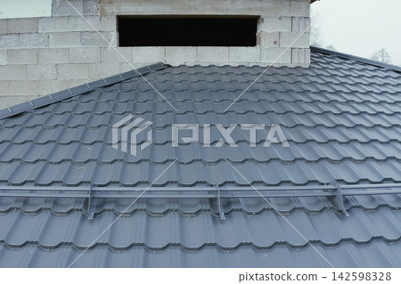 Corrugated metal roof and metal roofing. Modern roof made of metal. Corrugated metal roof and metal roofing. Modern roof made of metal. 142598328