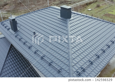 Corrugated metal roof and metal roofing. Modern roof made of metal. Corrugated metal roof and metal roofing. Modern roof made of metal. 142598329