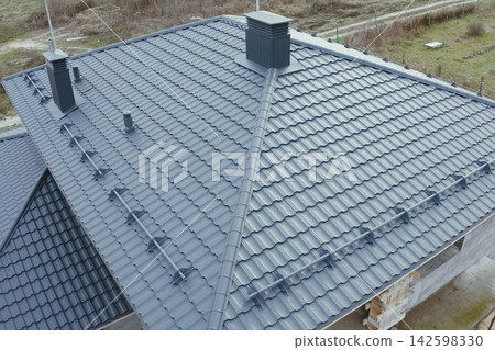 Corrugated metal roof and metal roofing. Modern roof made of metal. Corrugated metal roof and metal roofing. Modern roof made of metal. 142598330