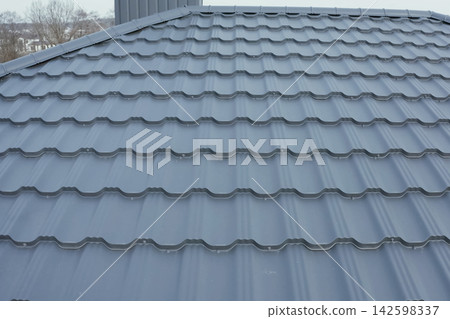 Corrugated metal roof and metal roofing. Modern roof made of metal. Corrugated metal roof and metal roofing. Modern roof made of metal. 142598337