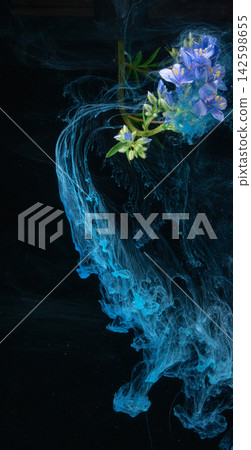 Blue wildflower cluster entwined with turquoise ink swirls closeup on black background Blue wildflower cluster entwined with turquoise ink swirls closeup on black background 142598655