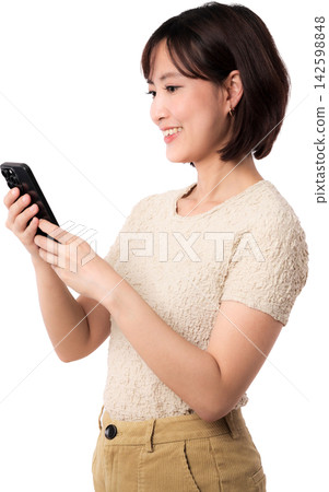 Asian woman using smartphone with joyful smile while standing in profile isolated on transparent background 142598848