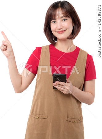 Asian woman holding smartphone and pointing upward with friendly smile isolated on transparent background Asian woman holding smartphone and pointing upward with friendly smile isolated on transparent background 142598873