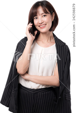 Young Asian woman smiling while holding smartphone and wearing striped blazer over white blouse Young Asian woman smiling while holding smartphone and wearing striped blazer over white blouse 142598879