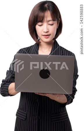 Asian woman using laptop with focused expression, isolated on transparent background for business and technology concept Asian woman using laptop with focused expression, isolated on transparent background for business and technology concept 142598883