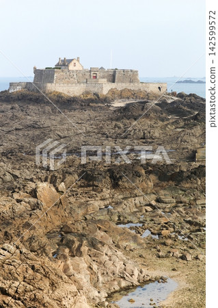 Fort National at low tide in Saint Malo in Brittany. Fort National is a fort on a tidal island a few hundred meters off the walled city of Saint-Malo, France Fort National at low tide in Saint Malo in Brittany. Fort National is a fort on a tidal island a few hundred meters off the walled city of Saint-Malo, France 142599572