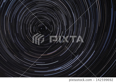 Long exposure starry sky, twisted tracks of stars. Long exposure starry sky, twisted tracks of stars. 142599692