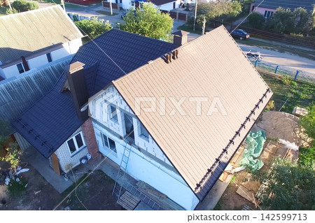 Corrugated metal roof and metal roofing. Modern roof made of metal. Corrugated metal roof and metal roofing. Modern roof made of metal. 142599713