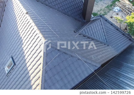 Corrugated metal roof and metal roofing. Modern roof made of metal. Corrugated metal roof and metal roofing. Modern roof made of metal. 142599726