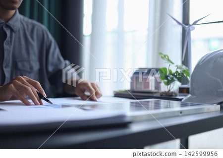 Architect Working on renewable Energy Housing Project. Architect Working on renewable Energy Housing Project. 142599956