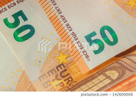 Fifty Euro Banknotes Close Up. Close-up of overlapping fifty euro banknotes, detailed currency design, denomination. European money background, finance, banking, savings, inflation and economy Fifty Euro Banknotes Close Up. Close-up of overlapping fifty euro banknotes, detailed currency design, denomination. European money background, finance, banking, savings, inflation and economy 142600008