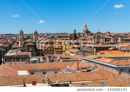 An aerial perspective showcases the dense urban landscape of an Italian city, characterized by its classic terracotta tiled roofs and prominent church architecture An aerial perspective showcases the dense urban landscape of an Italian city, characterized by its classic terracotta tiled roofs and prominent church architecture 142600143