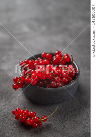 Fresh Red Currants in Ceramic Bowl on Dark Textured Background Fresh Red Currants in Ceramic Bowl on Dark Textured Background 142600307