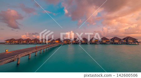 Dreamy overwater villas glowing pastel dusk calm vivid azure Maldives lagoon jetty warm reflected sky resort. Perfect summer travel vacation sunset holiday. Exotic honeymoon getaway paradise coast Dreamy overwater villas glowing pastel dusk calm vivid azure Maldives lagoon jetty warm reflected sky resort. Perfect summer travel vacation sunset holiday. Exotic honeymoon getaway paradise coast 142600506