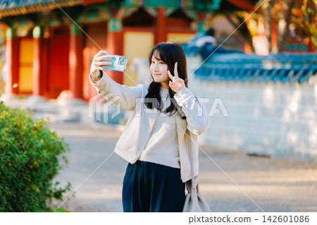 A woman enjoying sightseeing in Osaka in autumn A woman enjoying sightseeing in Osaka in autumn 142601086