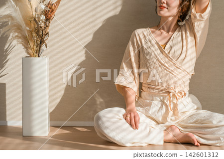 A woman relaxing in soft sunlight. A natural beauty with striking interplay of light and shadow. A woman relaxing in soft sunlight. A natural beauty with striking interplay of light and shadow. 142601312
