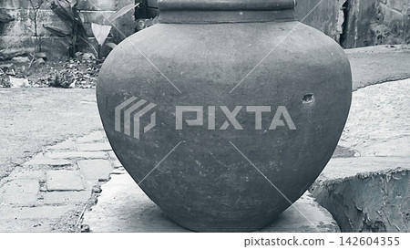 Monochrome View of a Traditional Clay Water Jar in a Rural Alley Monochrome View of a Traditional Clay Water Jar in a Rural Alley 142604355