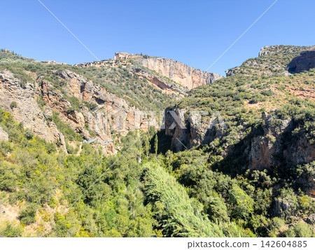 Fortified village of Alquezar and its collegiate church on limestone cliffs above the Rio Vero canyon Fortified village of Alquezar and its collegiate church on limestone cliffs above the Rio Vero canyon 142604885