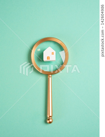 House and magnifying glass. Searching for housing. Renting or buying a home. Real estate research, property investment, mortgage decisions, housing market analysis, and relocation planning. 142604986