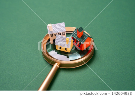 Houses under magnifying glass, real estate inspection and analysis concept. Property valuation, housing research and investment decisions depend on location, market prices and development potential. Houses under magnifying glass, real estate inspection and analysis concept. Property valuation, housing research and investment decisions depend on location, market prices and development potential. 142604988