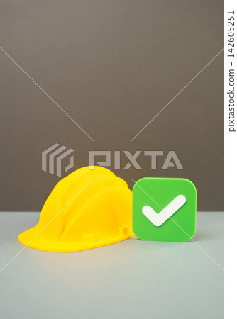 Construction helmet and approval checkmark, building permit approval, license approval concept. Construction authorization, regulatory compliance, certification and official permission 142605251