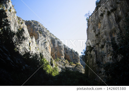 Backlit limestone canyon walls of the Rio Vero seen from the shaded canyon floor Backlit limestone canyon walls of the Rio Vero seen from the shaded canyon floor 142605380