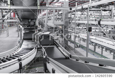packing line in a logistics warehouse. conveyor belt in a modern production line packing line in a logistics warehouse. conveyor belt in a modern production line 142605590