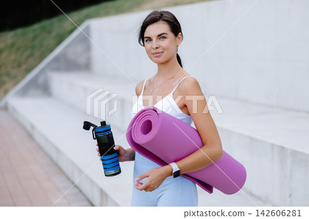 Young woman drinking water after outdoor workout Young woman drinking water after outdoor workout 142606281