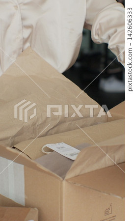 Vertical video. Unboxing Online Shop Purchase: Woman Opening Parcel Box at Home. Vertical video. Unboxing Online Shop Purchase: Woman Opening Parcel Box at Home. 142606333