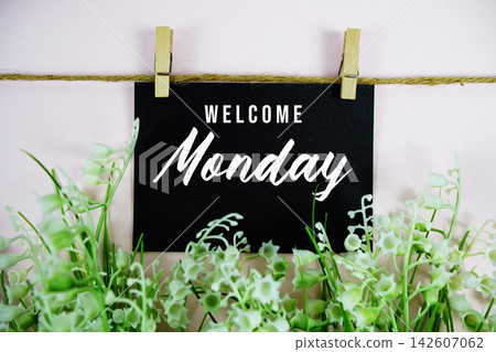 Welcome Monday written on paper card with flowers decoration Welcome Monday written on paper card with flowers decoration 142607062