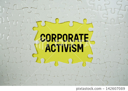 Jigsaw puzzle with a missing piece with "Corporate Activism" on yellow background Jigsaw puzzle with a missing piece with "Corporate Activism" on yellow background 142607089