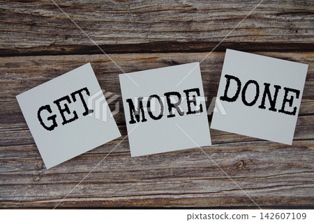 Get More Done message on paper note flat lay on wooden background 142607109