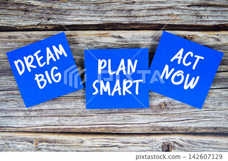 Dream Big, Plan Smart, Act Now message on paper note flat lay on wooden background Dream Big, Plan Smart, Act Now message on paper note flat lay on wooden background 142607129