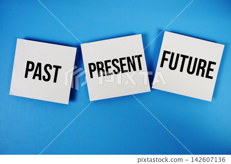 Past Present Future message on paper note flat lay on blue background Past Present Future message on paper note flat lay on blue background 142607136