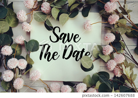 Save The Date text with flower decoration on wooden background Save The Date text with flower decoration on wooden background 142607688
