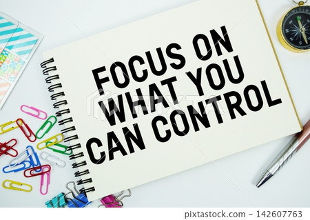 Focus On What You Can Control text message written on notepad with stationery flat lay on white background 142607763