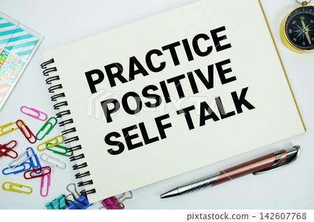Practice Positive Self Talk text message written on notepad with stationery flat lay on white background Practice Positive Self Talk text message written on notepad with stationery flat lay on white background 142607768