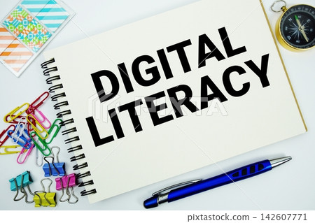 Digital Literacy text message written on notepad with stationery flat lay on white background Digital Literacy text message written on notepad with stationery flat lay on white background 142607771