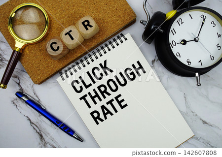CTR Click Through Rate text written on notepad with magnifying glass and alarm clock on marble background CTR Click Through Rate text written on notepad with magnifying glass and alarm clock on marble background 142607808
