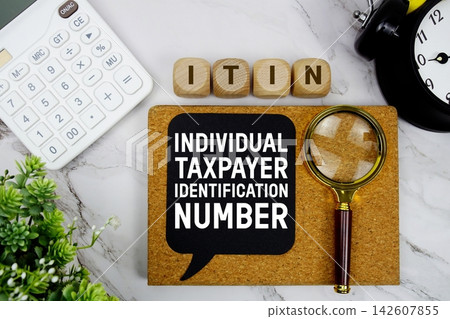 ITIN Individual Taxpayer Identification Number text with calculator, magnifying glass and alarm clock on marble background ITIN Individual Taxpayer Identification Number text with calculator, magnifying glass and alarm clock on marble background 142607855