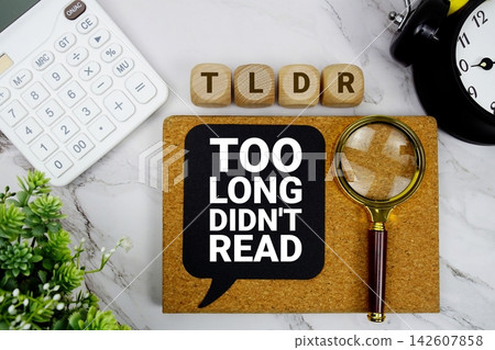 TLDR Too Long Didn't Read text with calculator, magnifying glass and alarm clock on marble background TLDR Too Long Didn't Read text with calculator, magnifying glass and alarm clock on marble background 142607858