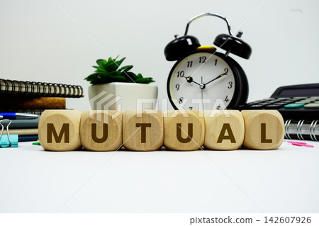 MUTUAL alphabet letters with alarm clock and calculator on white background MUTUAL alphabet letters with alarm clock and calculator on white background 142607926