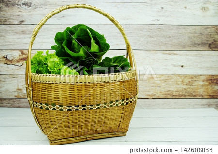 Fresh raw Iceberg, Romaine and Green Cos lettuces in bamboo basket on wooden background Fresh raw Iceberg, Romaine and Green Cos lettuces in bamboo basket on wooden background 142608033